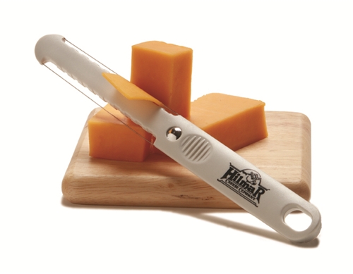Hilmar Cheese cheese slicer cutting cheddar cheese.